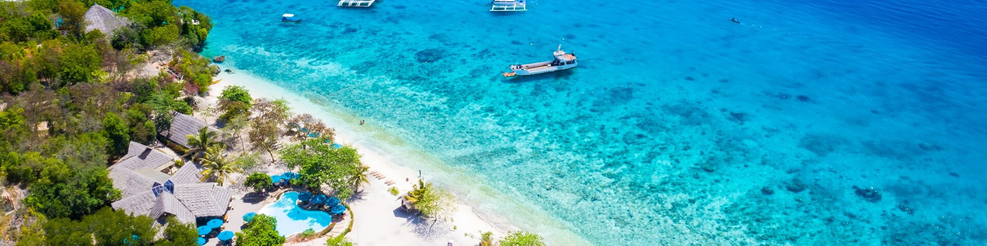 Panorama with a aerial top view as perspective of the Sumilon island beach landing near Oslob, Cebu, Philippines.