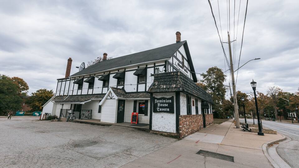 A historic building with a sign reading "Dominion House Tavern."