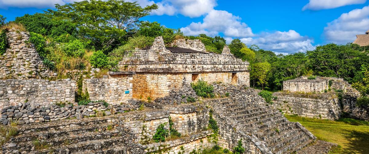 Ancient stone ruins with stepped structures and a clear blue sky.