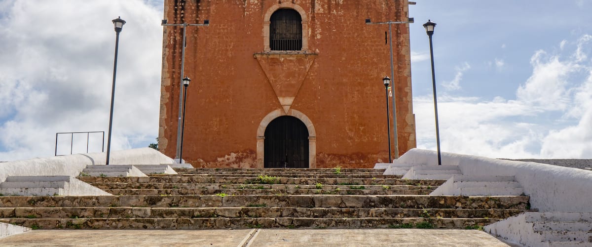 A historic church with a large arched entrance and two bell towers.