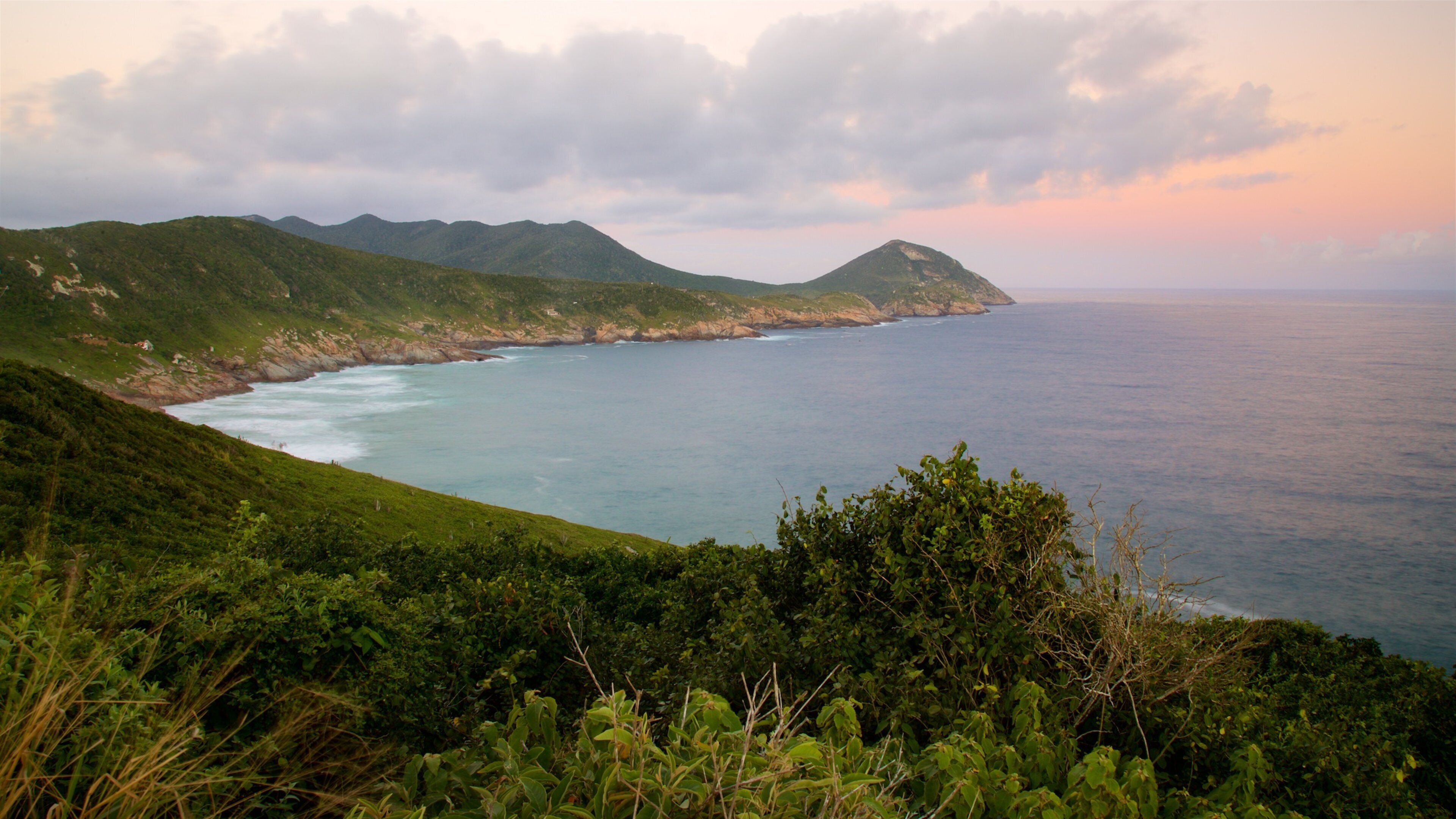 Atalaia Viewpoint featuring rocky coastline, a sunset and general coastal views