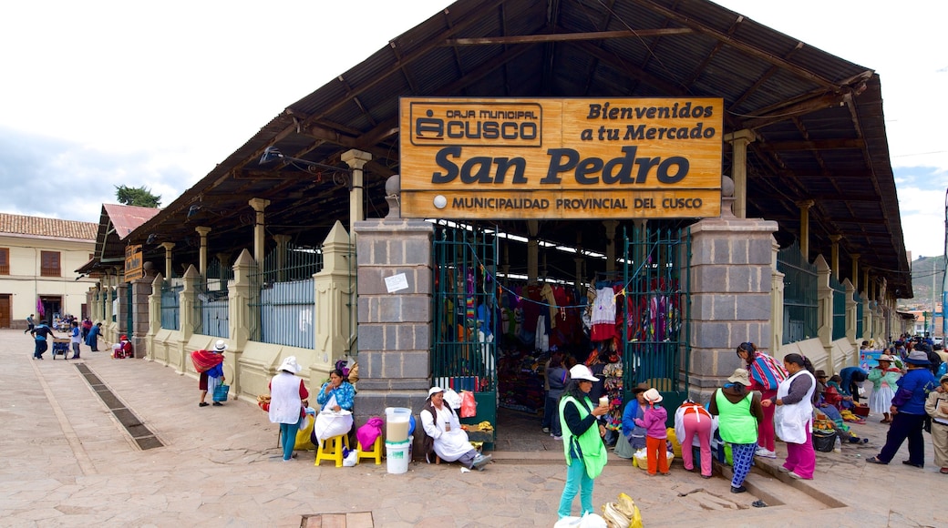 Cusco San Pedro Market featuring markets as well as a small group of people