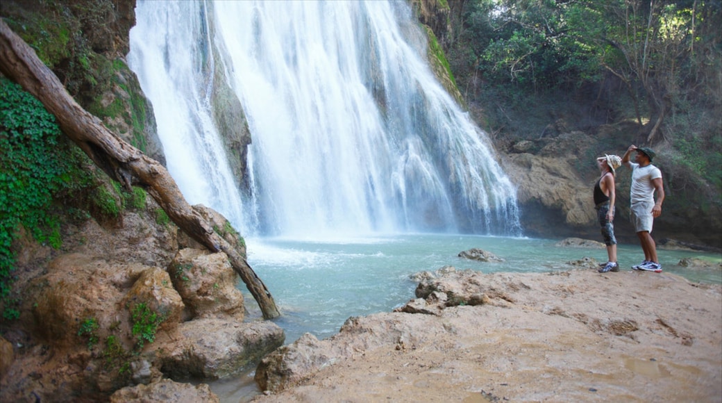 El Limon Falls showing hiking or walking and a waterfall as well as a couple