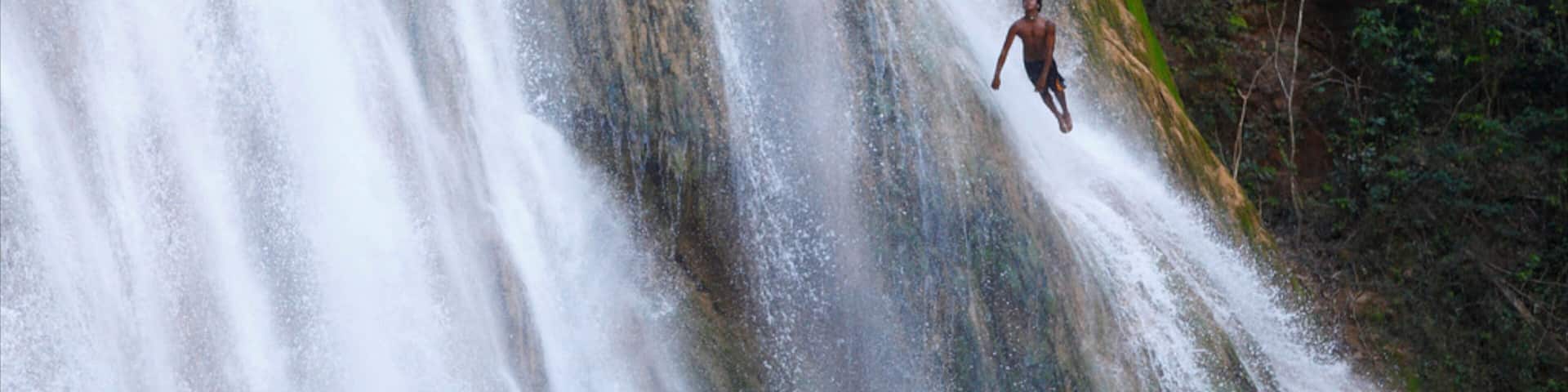 El Limon Falls featuring a waterfall as well as an individual male