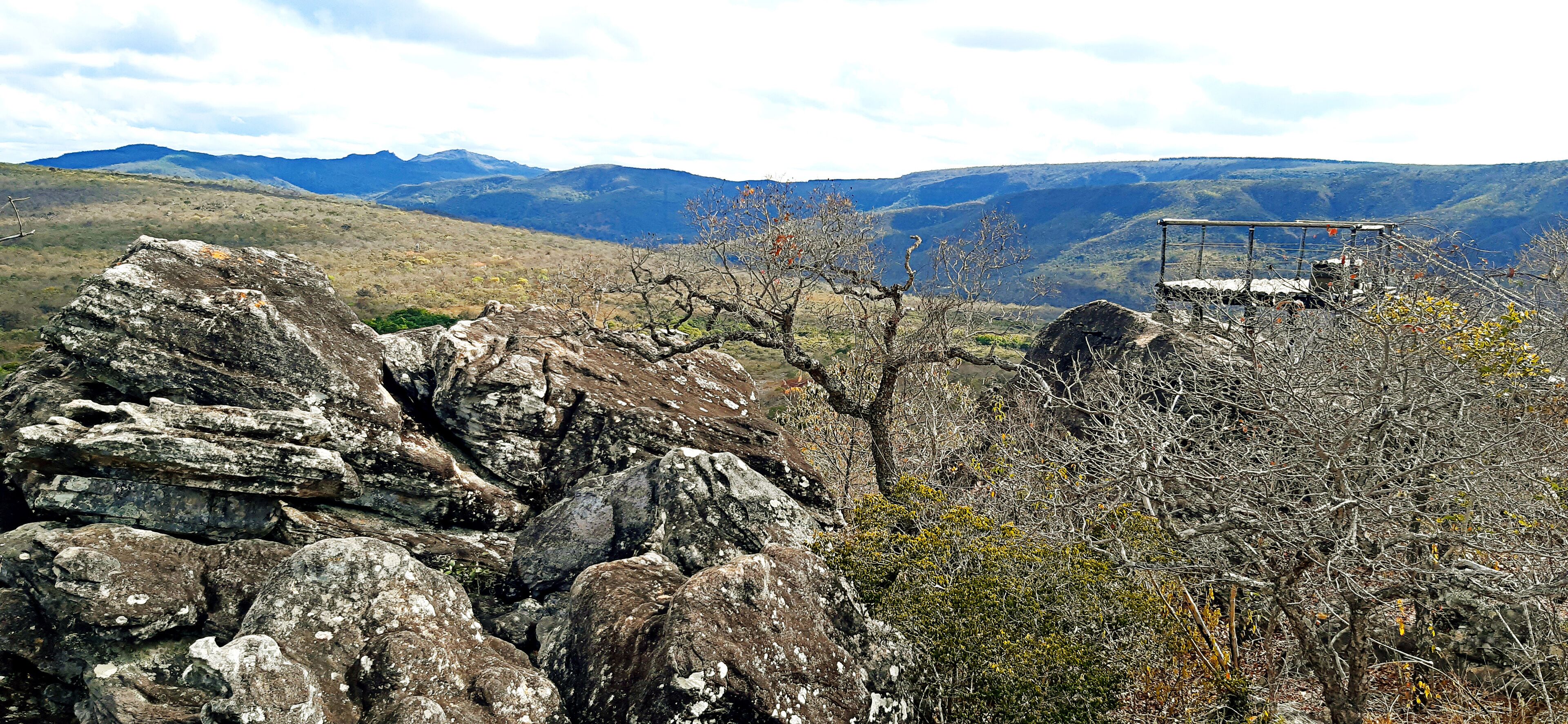 A rocky landscape with a metal structure on a hill.