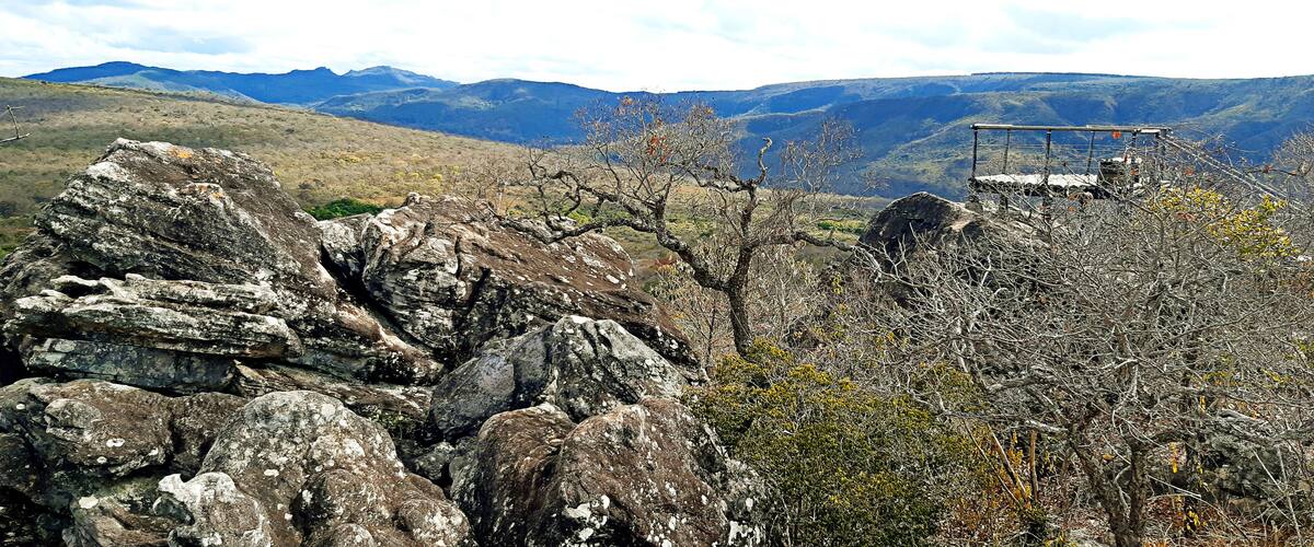 A rocky landscape with a metal structure on a hill.