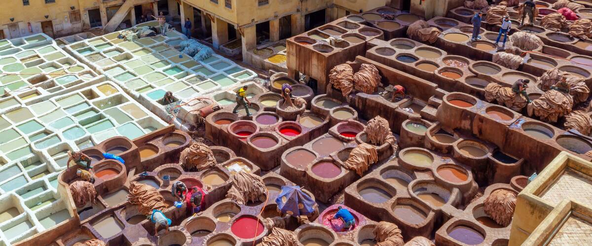 A traditional dyeing area with multiple vats of different colors.