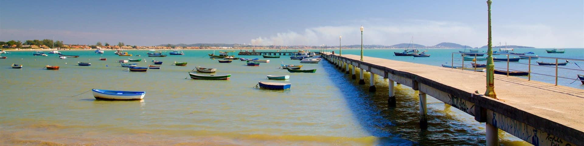 Manguinhos Beach which includes general coastal views, a beach and a bay or harbour