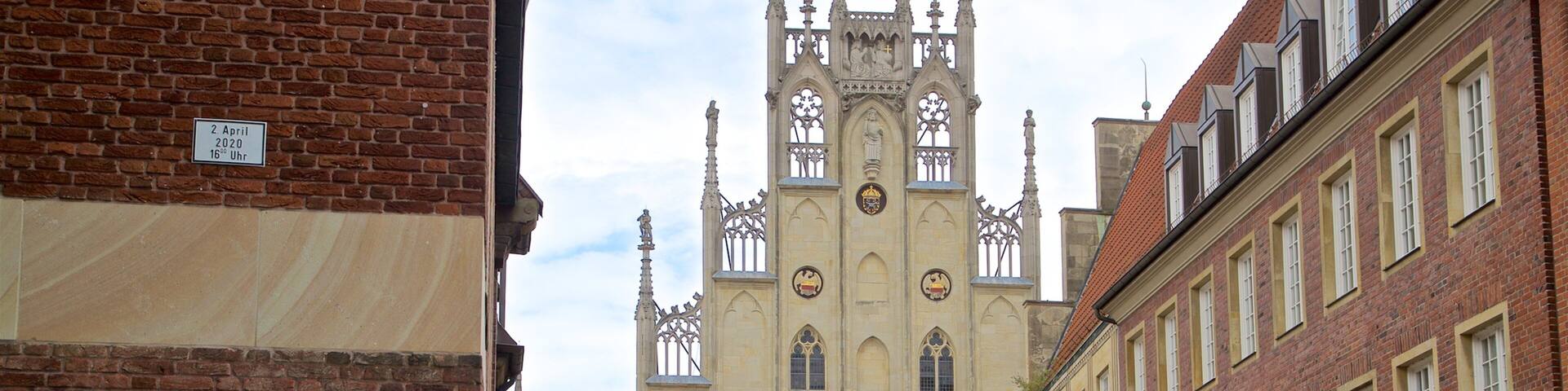 A historic building with a tall tower and arched windows.