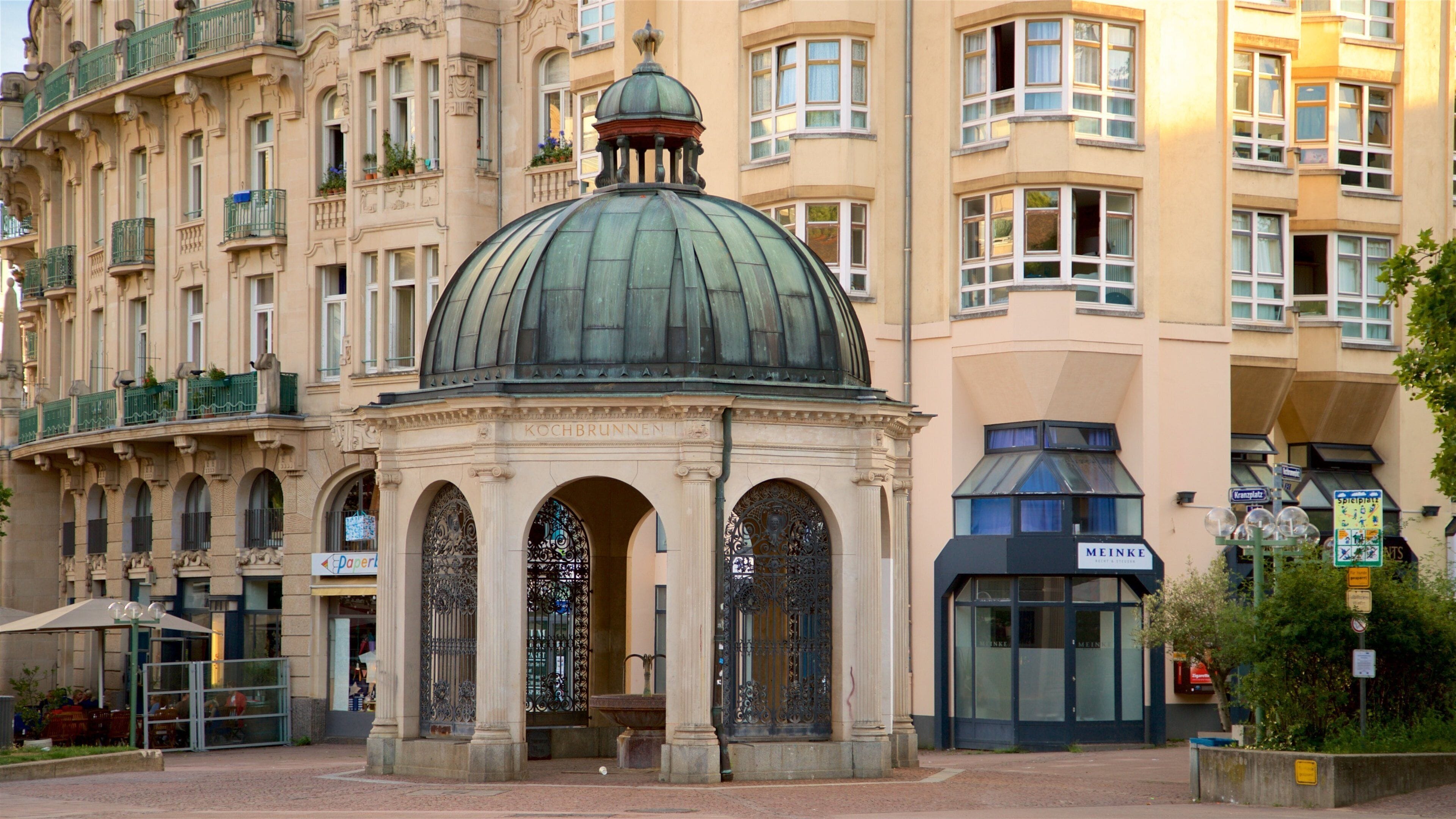 Um edifício histórico com uma cúpula imponente e portões de ferro elaborados.