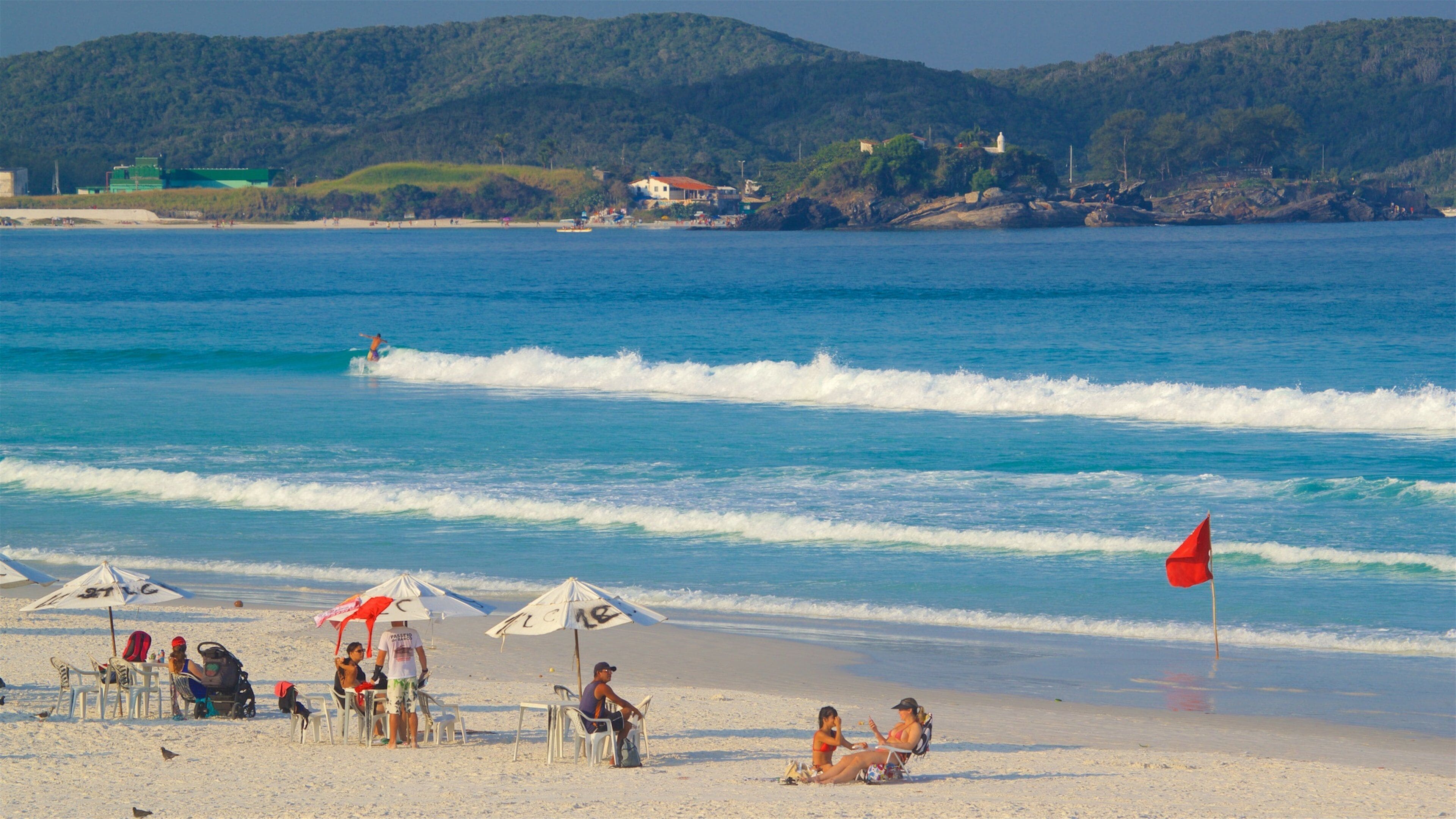 Dunas Beach featuring general coastal views and a sandy beach as well as a small group of people