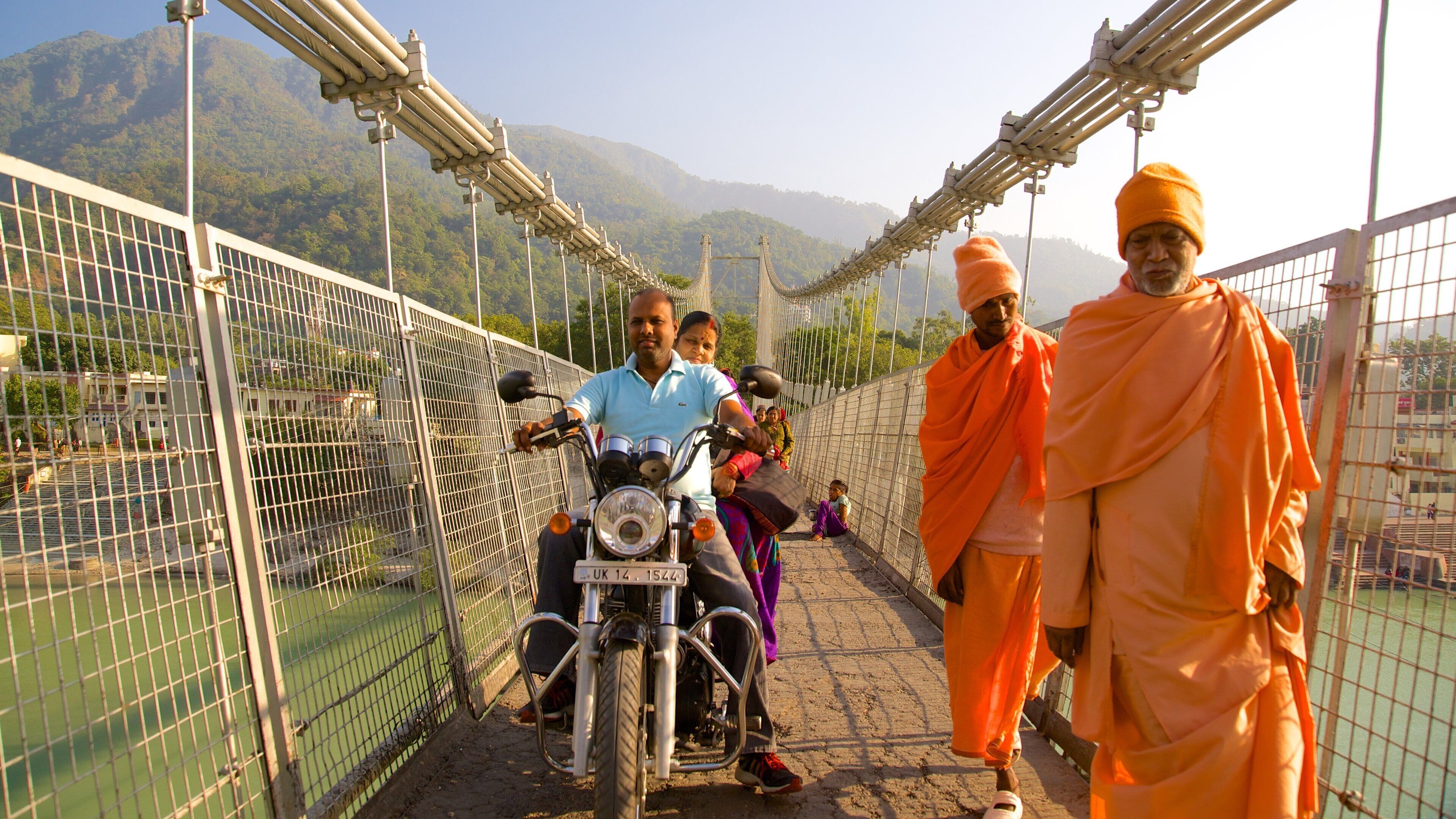 Ram Jhula showing a river or creek, a bridge and a small town or village