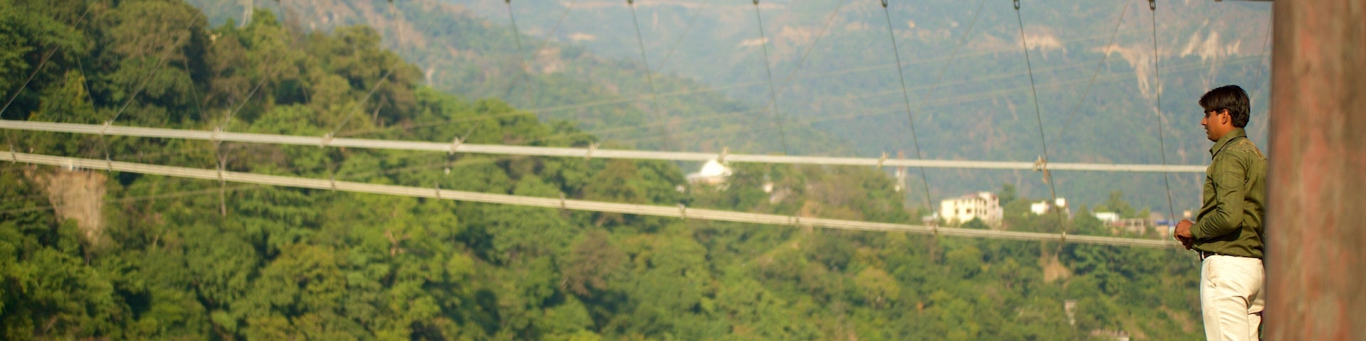 Ram Jhula showing a small town or village, a river or creek and a bridge