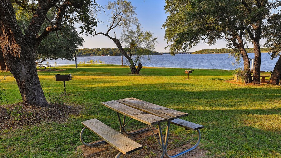 Picnic tables are located all along the lake at Lake Brownwood State Park.