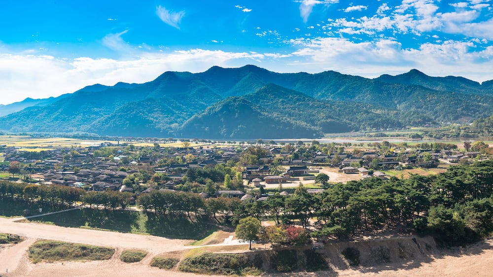 A mountainous landscape with a village nestled among the hills.