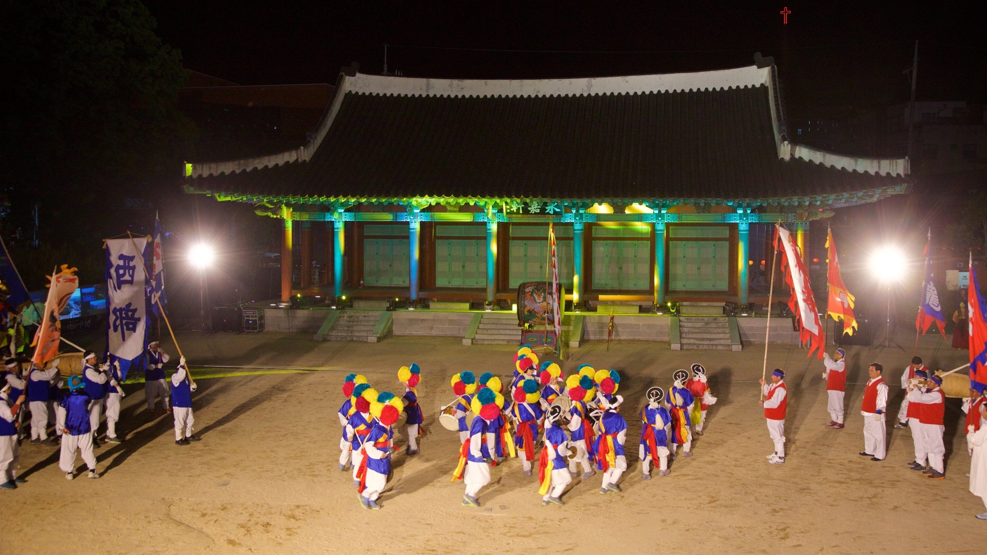 Andong showing night scenes and performance art as well as a small group of people