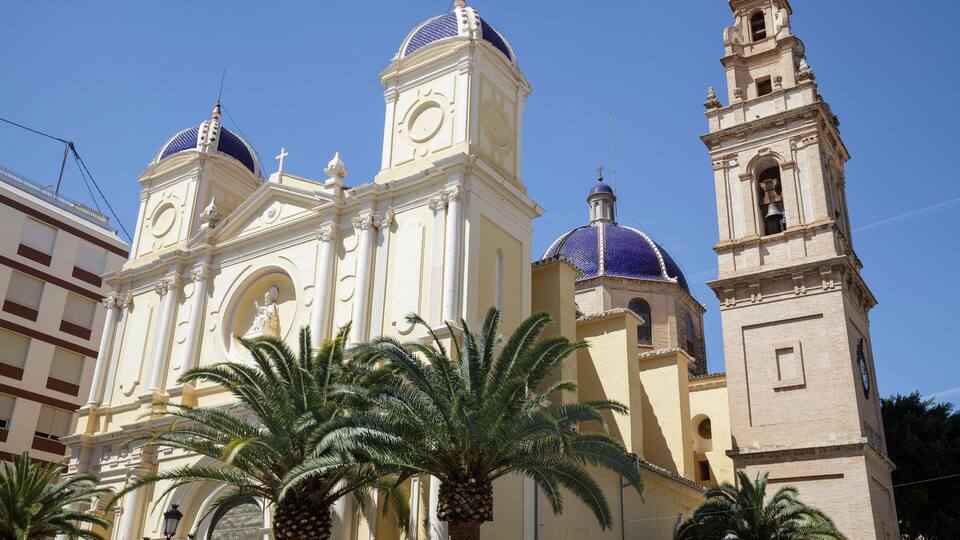 A historic church with a bell tower and domed towers.