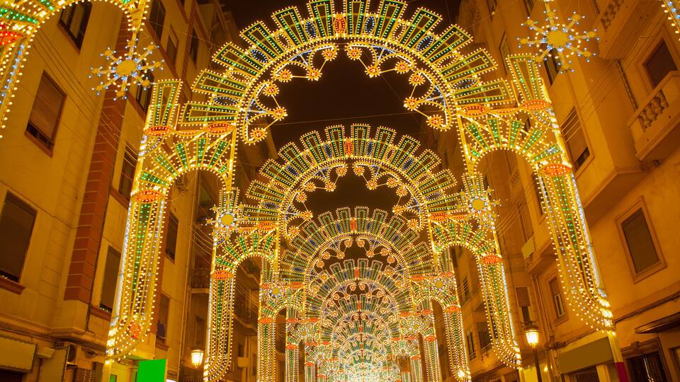 A street decorated with elaborate, illuminated arches and columns.