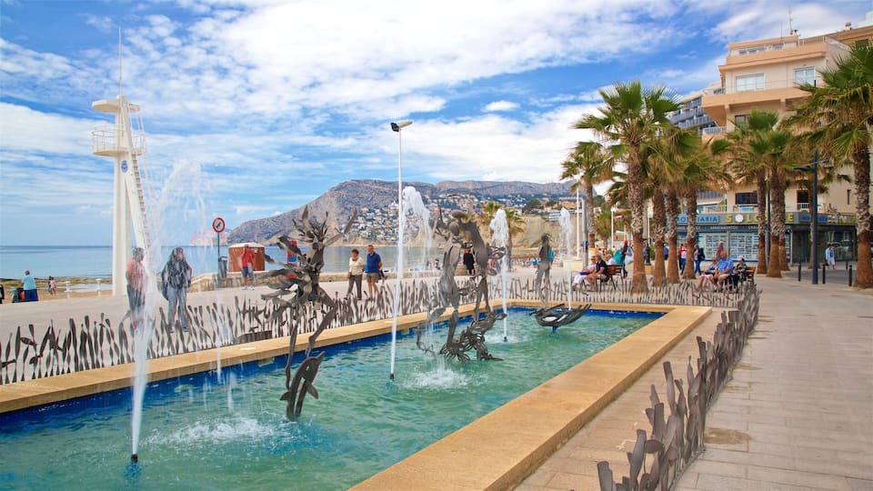 Arenal-Bol Beach showing a coastal town, a fountain and outdoor art