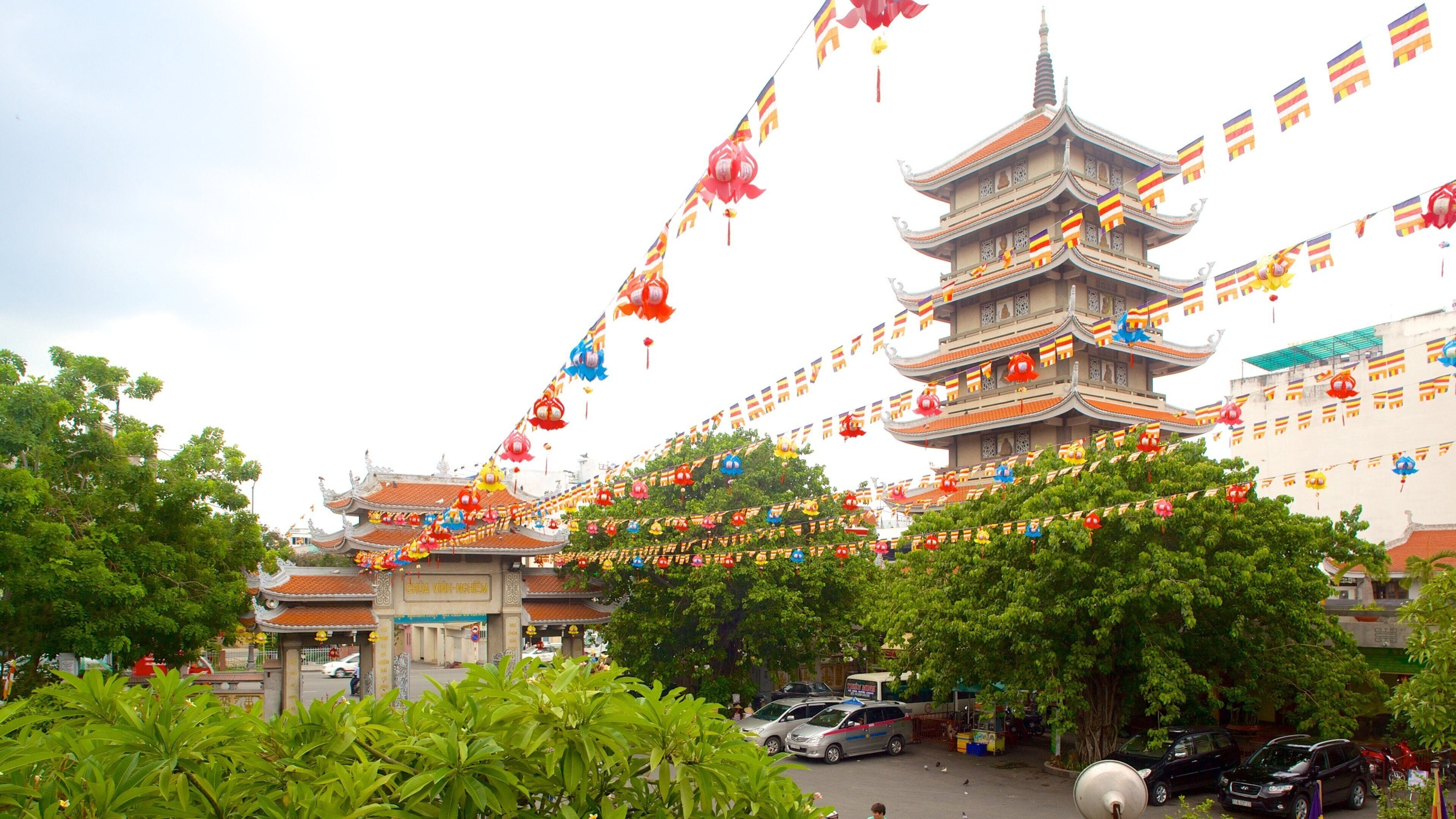 A traditional multi-tiered pagoda with colorful decorations and flags.