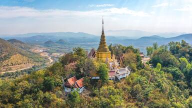 Aerial view of Wat Phra Phutthabat Tak Pha temple on top of the mountain in Lamphun, Thailand