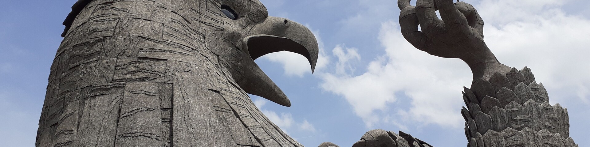 A large stone eagle sculpture with outstretched talons.