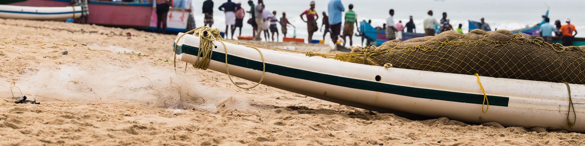 Fishing boat with net and fishermen on backside waiting a catch.