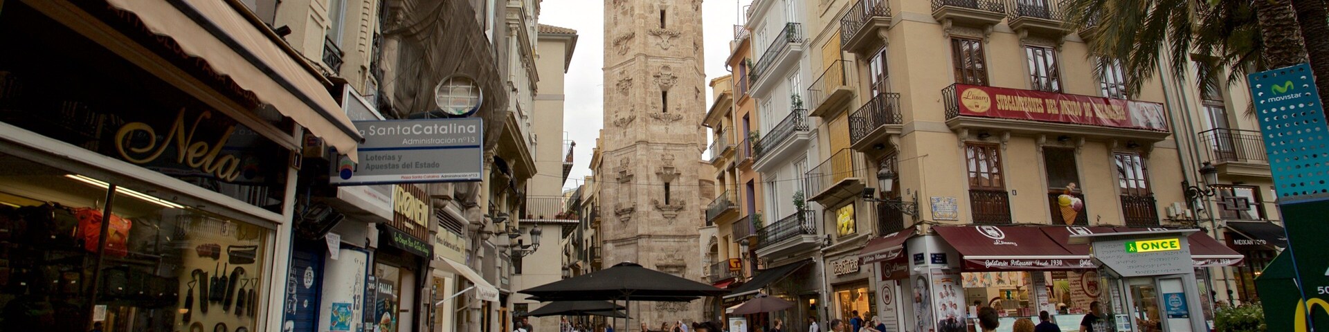 Santa Catalina Church and Tower showing heritage elements and street scenes as well as a family