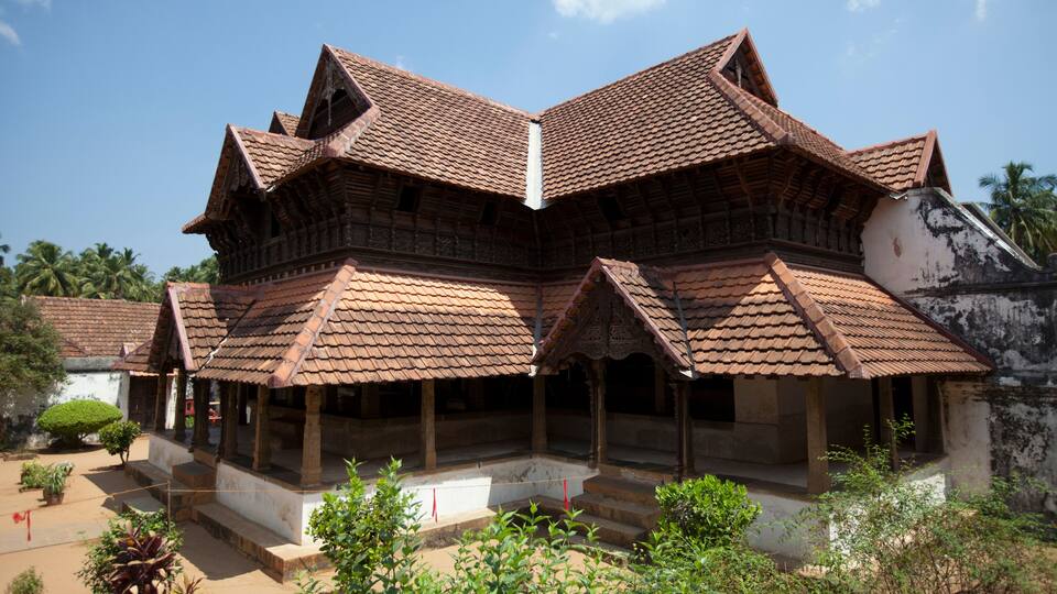 A traditional multi-tiered building with a tiled roof and a courtyard.