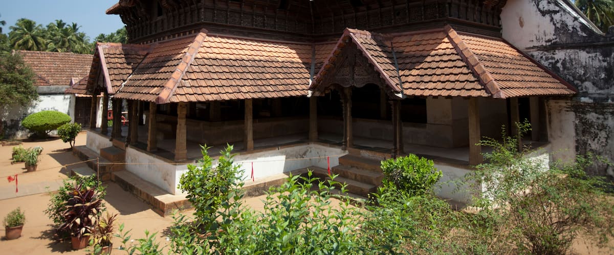 A traditional multi-tiered building with a tiled roof and a courtyard.