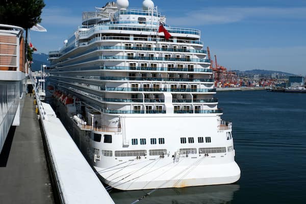 huge cruise liner stands off the coast of Vancouver Canada Place flag flying over the Pacific Ocean sails a beautiful view of the city on the water Canada 2023