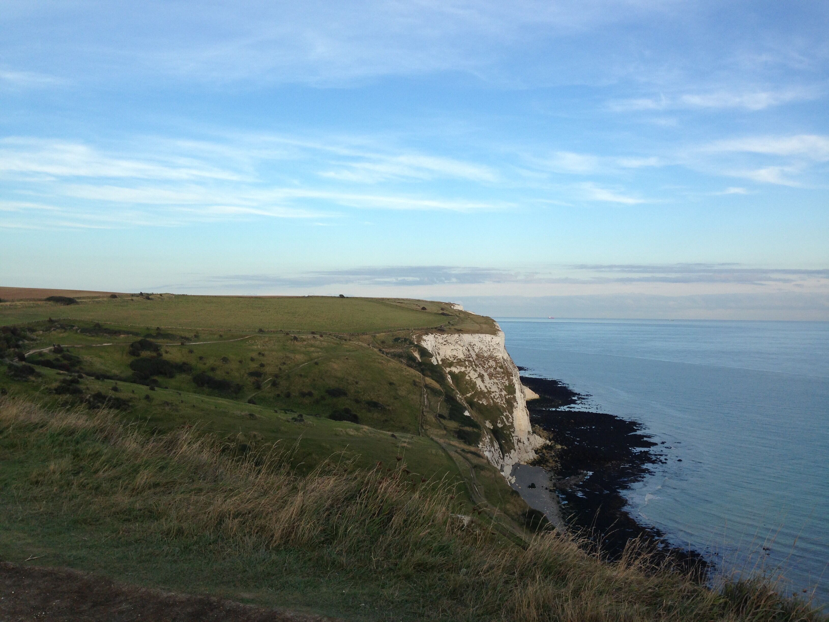 The White Cliffs of Dover, part of the North Downs formation, is the name given to the region of English coastline facing the Strait of Dover and France. The cliff face, which reaches a height of 350 feet, owes its striking appearance to its composition of chalk accented by streaks of black flint.