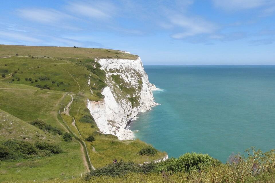 A coastal cliff with a clear view of the ocean.