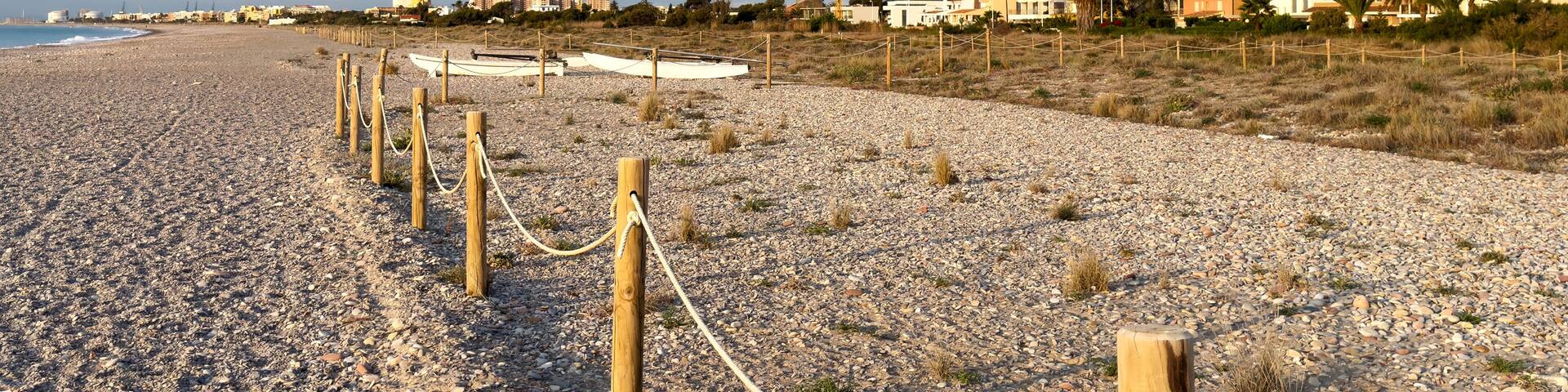 Pebble stone beach. Sea beach ocean shore. Coastline on empty pebble beach. Sea beach landscape. Coast pebbles. Shore landscape on Spain resort, Almarda. House on coastline. Waterfront vacation home