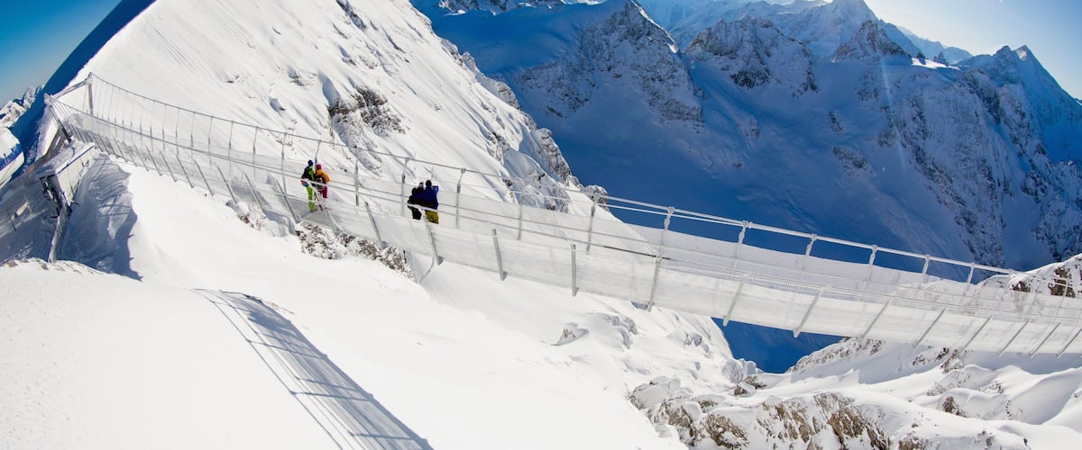 Engelberg-Titlis Ski Resort which includes snow, a suspension bridge or treetop walkway and mountains