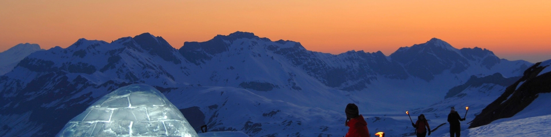 Engelberg-Titlis Ski Resort which includes a sunset and snow as well as a small group of people