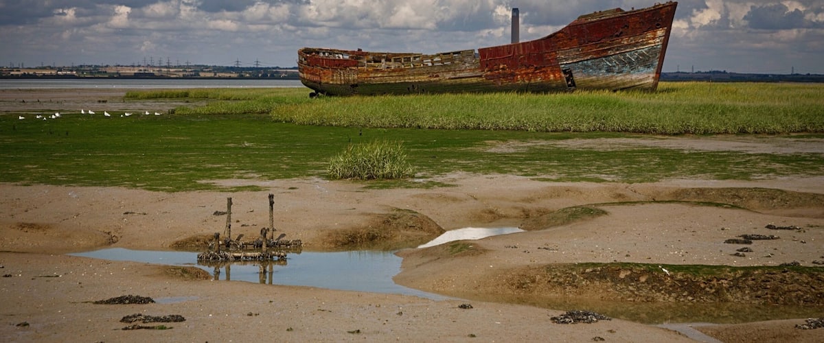 Wreck of an old boat, sitting just off the river side at Motney Hill, North Kent.
Part of the Riverside Country Park, this coastal walk takes in a varied amount of wildlife, from many species of birds who dwell in the salt marshes and mudflats to the seals often seen sitting on the little islands dotted around the estuary.