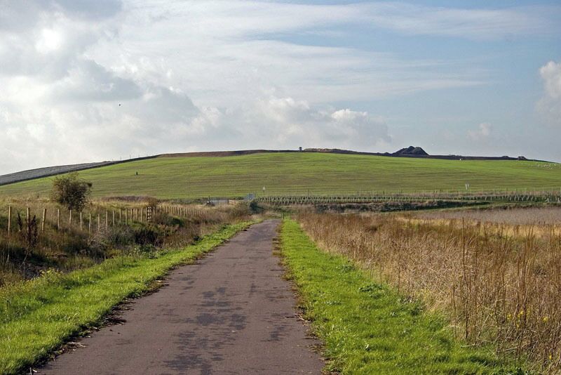 National Cycle Route 13 This is National Cycle Route 13 as it passes through Aveley / Rainham Marshes. Until earlier this year this square was inaccessible to the general public as it was partly on the Purfleet Ranges and the landfill site that is the hill in the back ground of the photo. Cycle Route 13 when finished will be able to take you to Fakenham in Norfolk or heading in the direction of the photo Hackney.