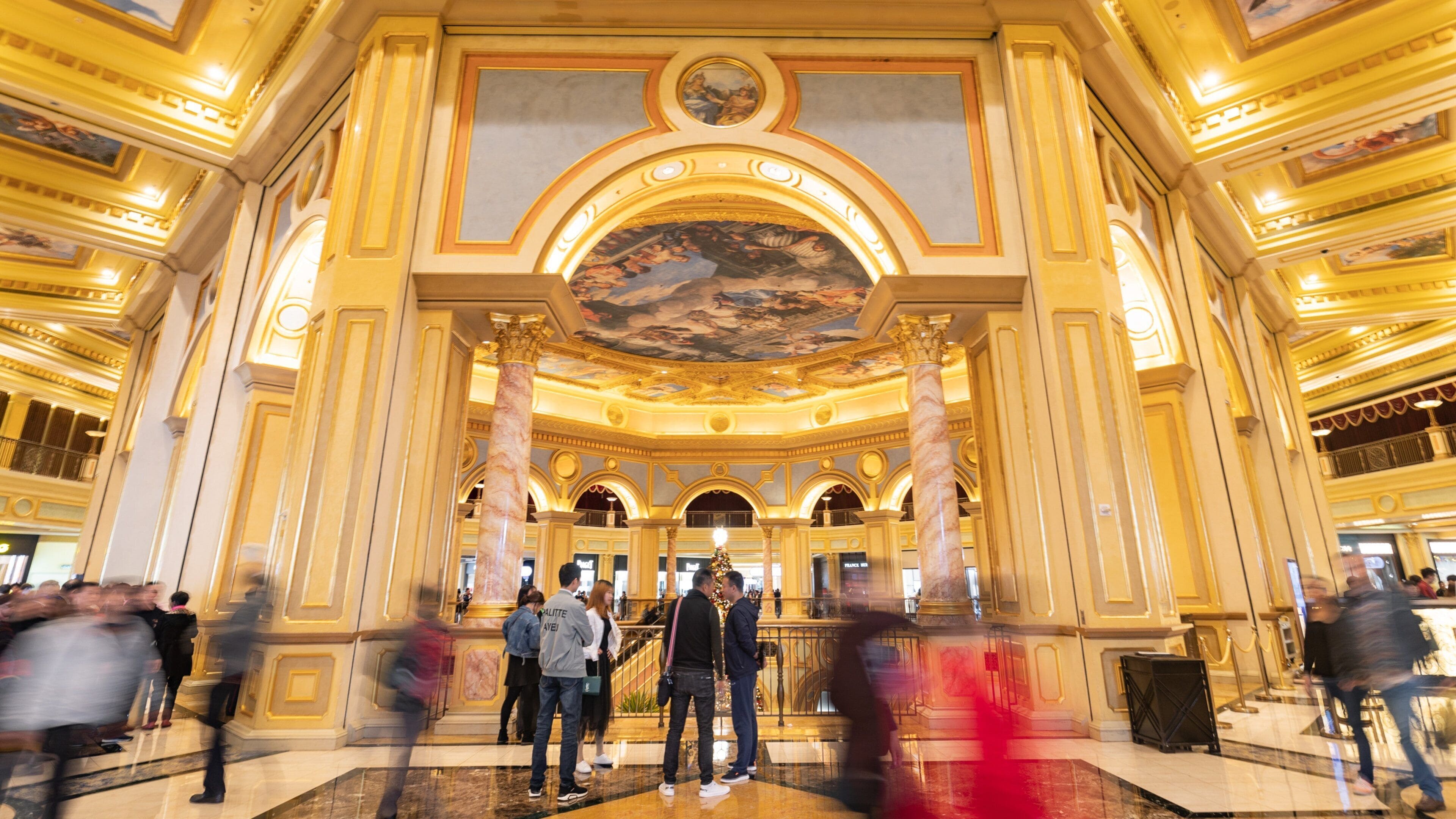 Venetian Macao Casino featuring heritage elements and interior views as well as a small group of people