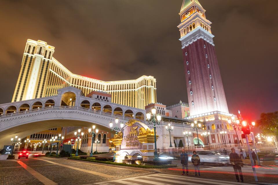 The Venetian Hotel with a prominent tower and a bridge.
