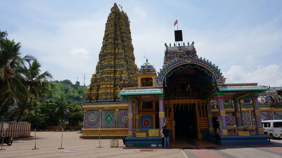 A temple with a tall spire and colorful decorations.