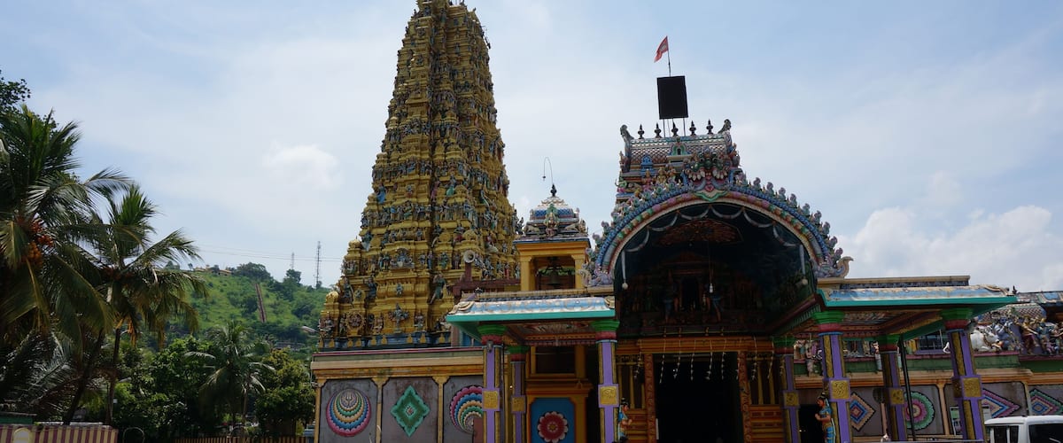 A temple with a tall spire and colorful decorations.