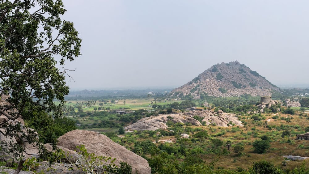 A mountainous landscape with ancient ruins and a prominent temple.