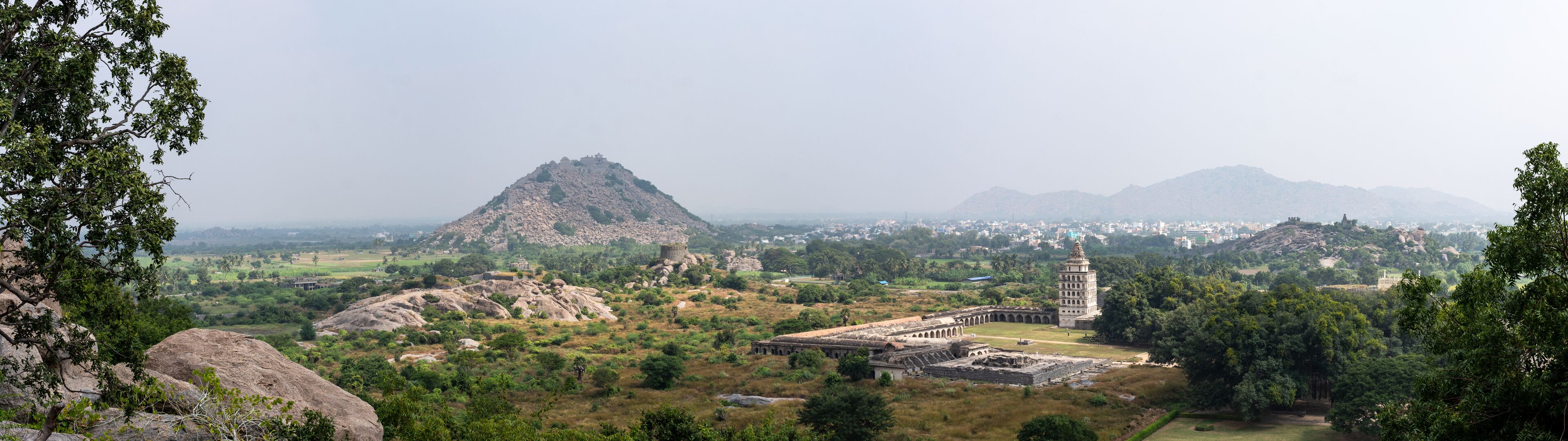 A mountainous landscape with ancient ruins and a prominent temple.
