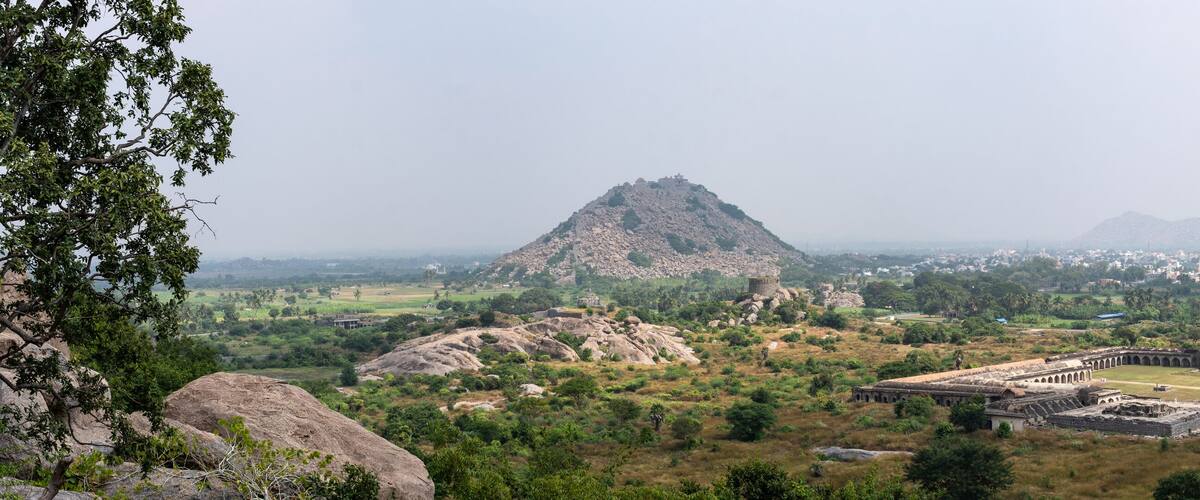 A mountainous landscape with ancient ruins and a prominent temple.