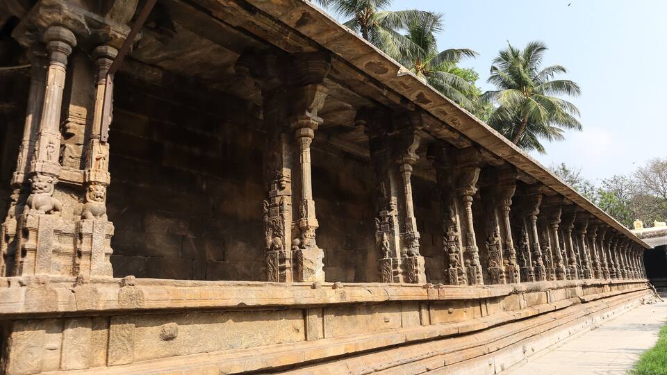 A stone corridor with intricate carvings and columns.