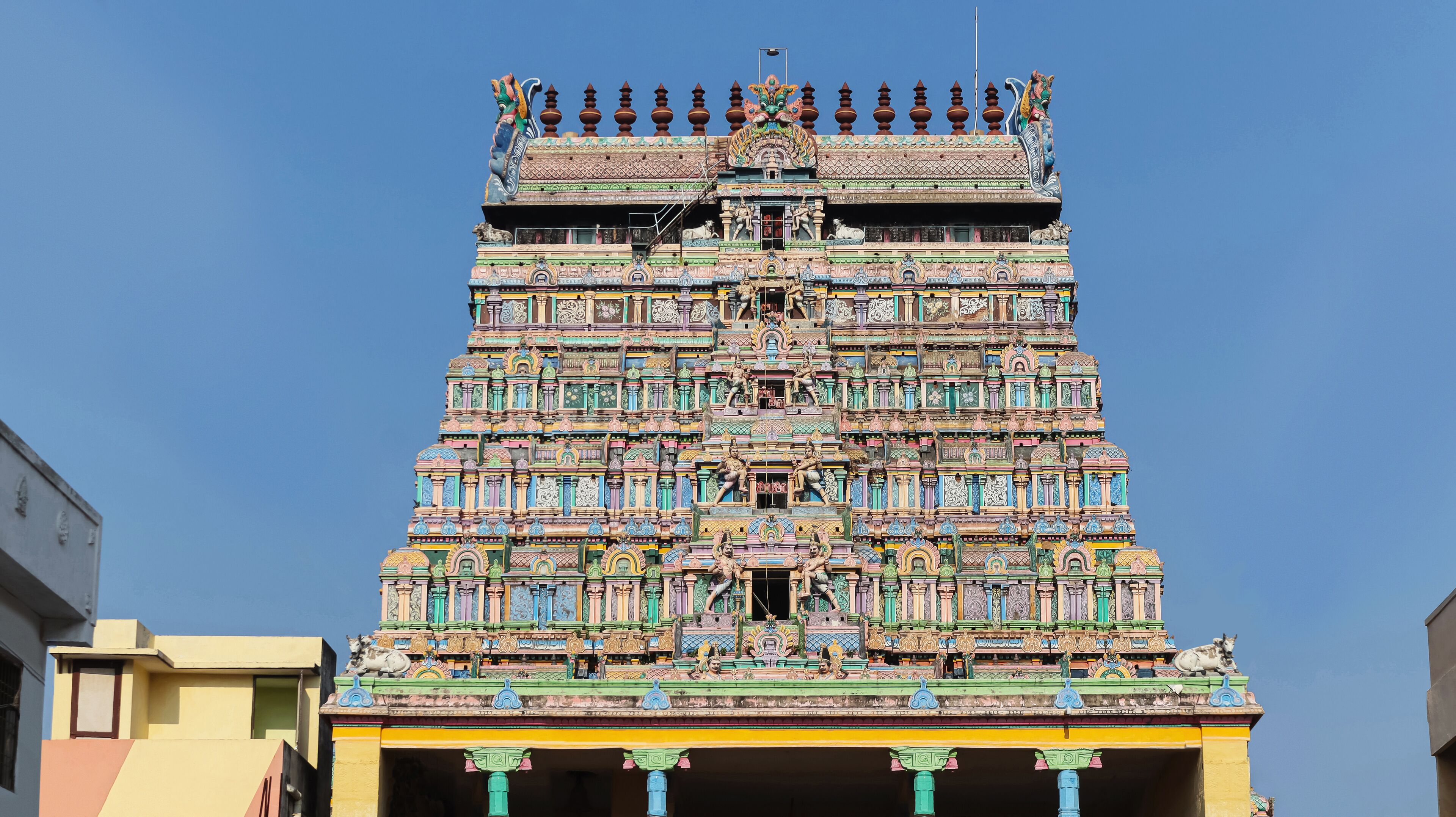 A colorful temple with intricate carvings and statues.