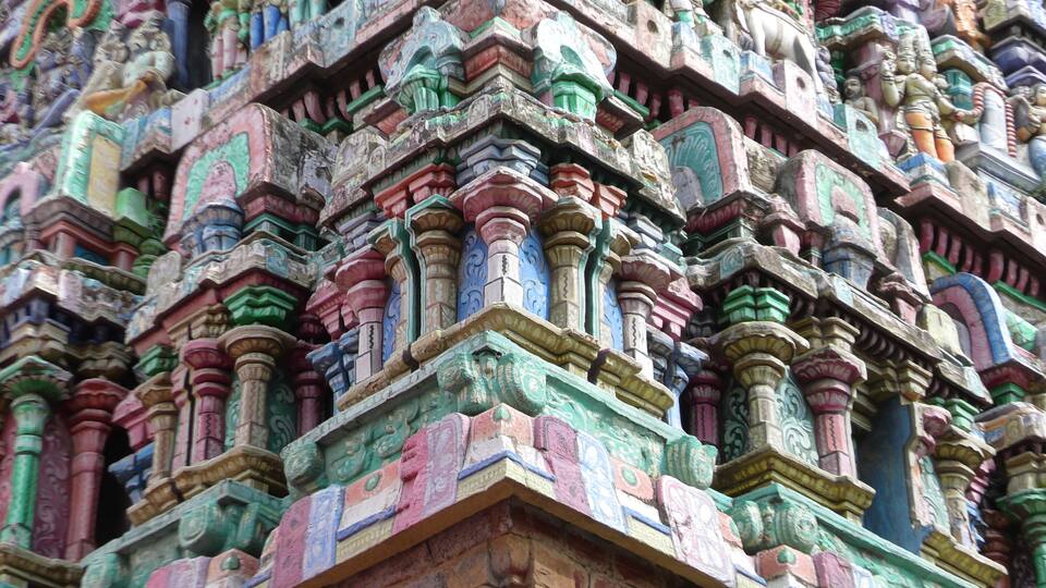 A detailed temple facade with colorful carvings and intricate architectural designs.