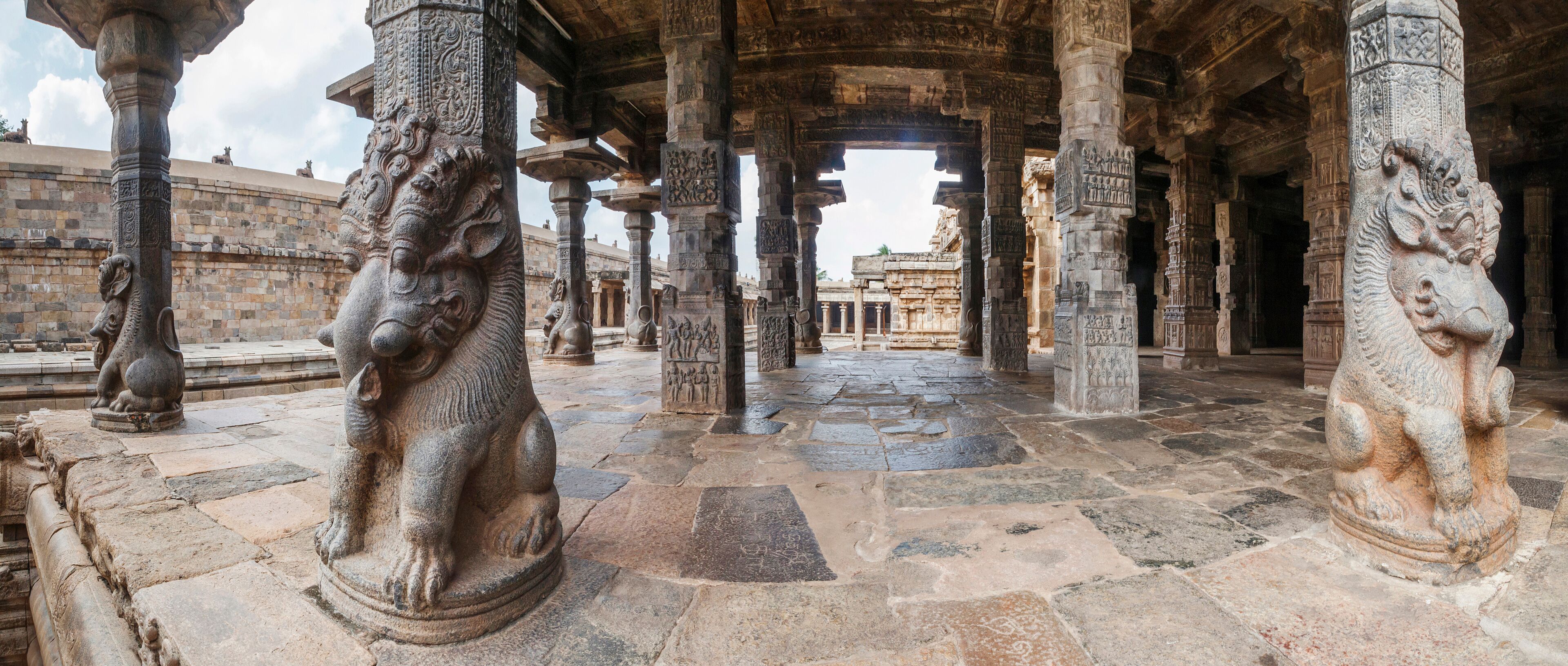 An ancient stone structure with intricate carvings and lion statues.
