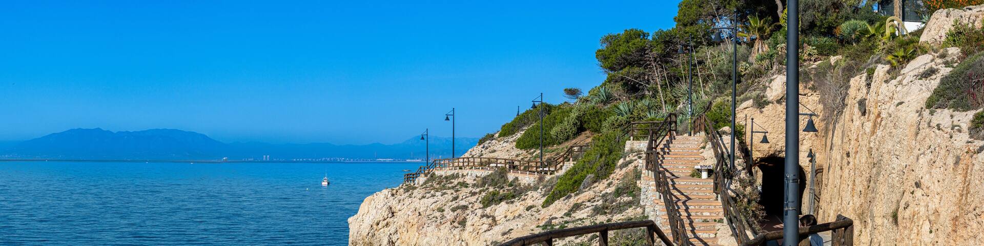 Morning walking on paths above rocks and through "El Cantal" tunnels in Rincon de la Victoria, Spain